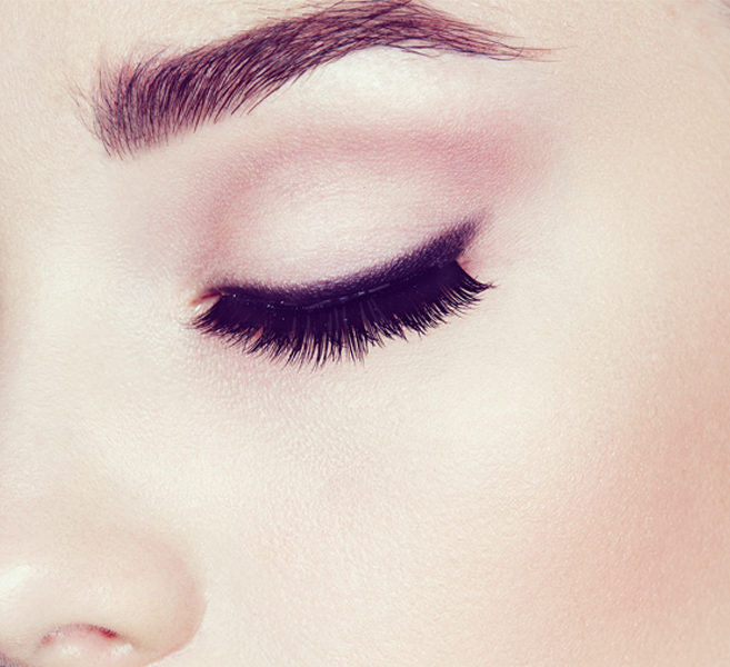close-up of a woman with long, dark eyelashes